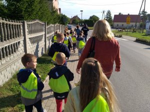 Dzieci w trakcie spotkania z dzielnicowym spacerują w miejscowości Radzieja